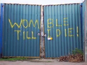 Gates at Plough Lane with the graffiti "Womble Till I Die"